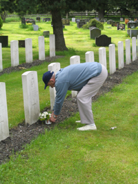 John putting flowers on Rusty's grave